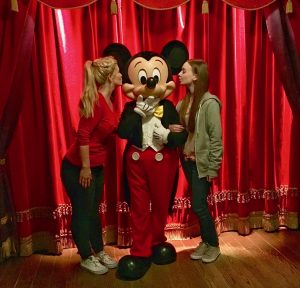 pippa and izzy stood either side of and posing with mickey mouse
